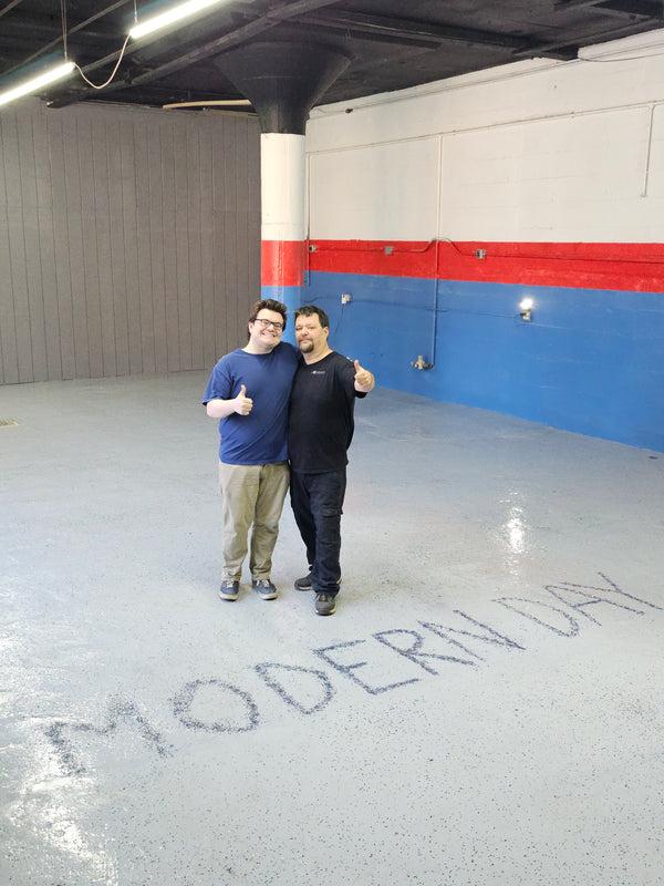 The father-and-son team at Modern Day Muffler & Brakes standing in their Wadsworth shop bay